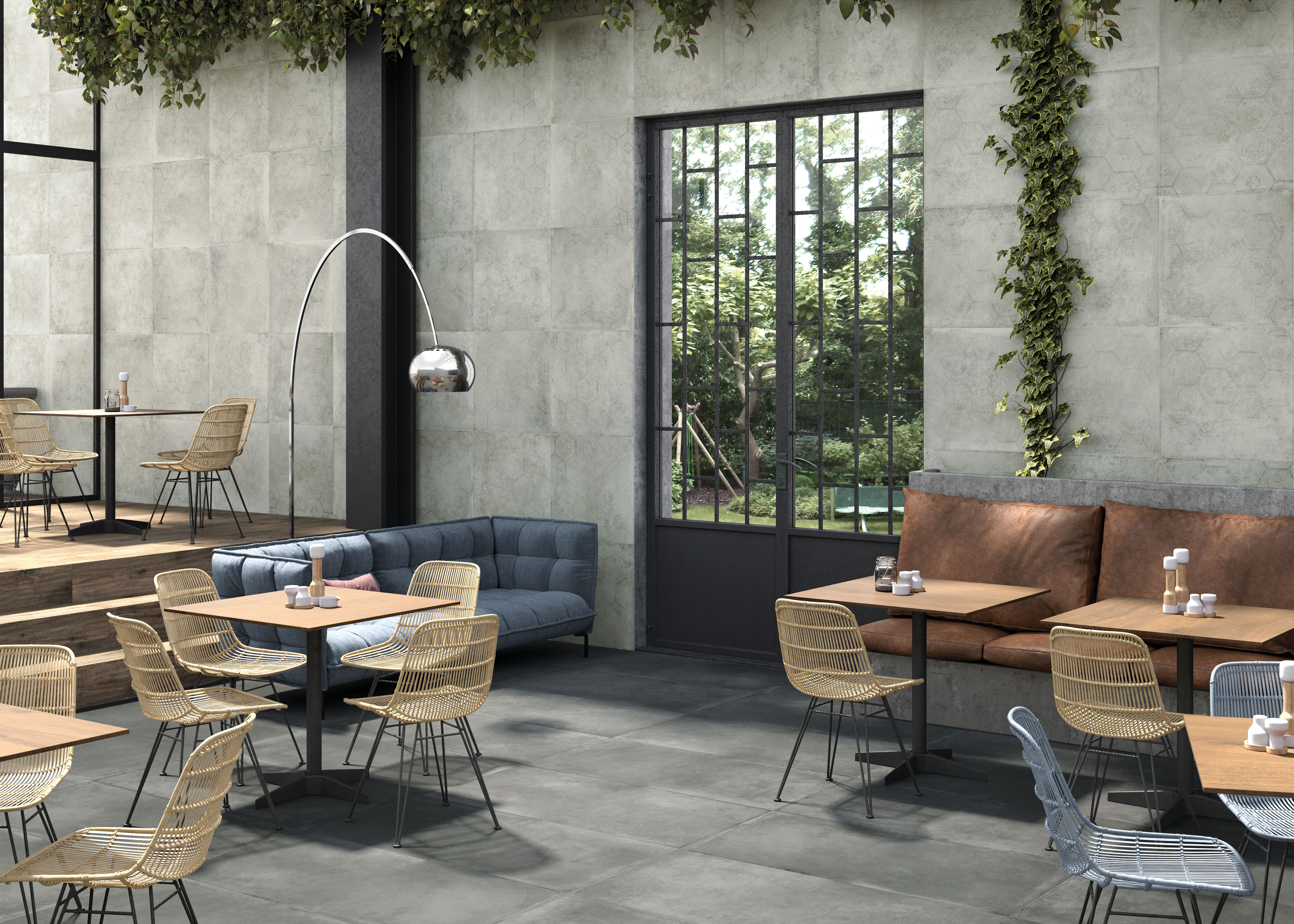 Großformatige Porcelaingres Betonoptik-Fliesen an Wand und Boden in modernem Café-Design.