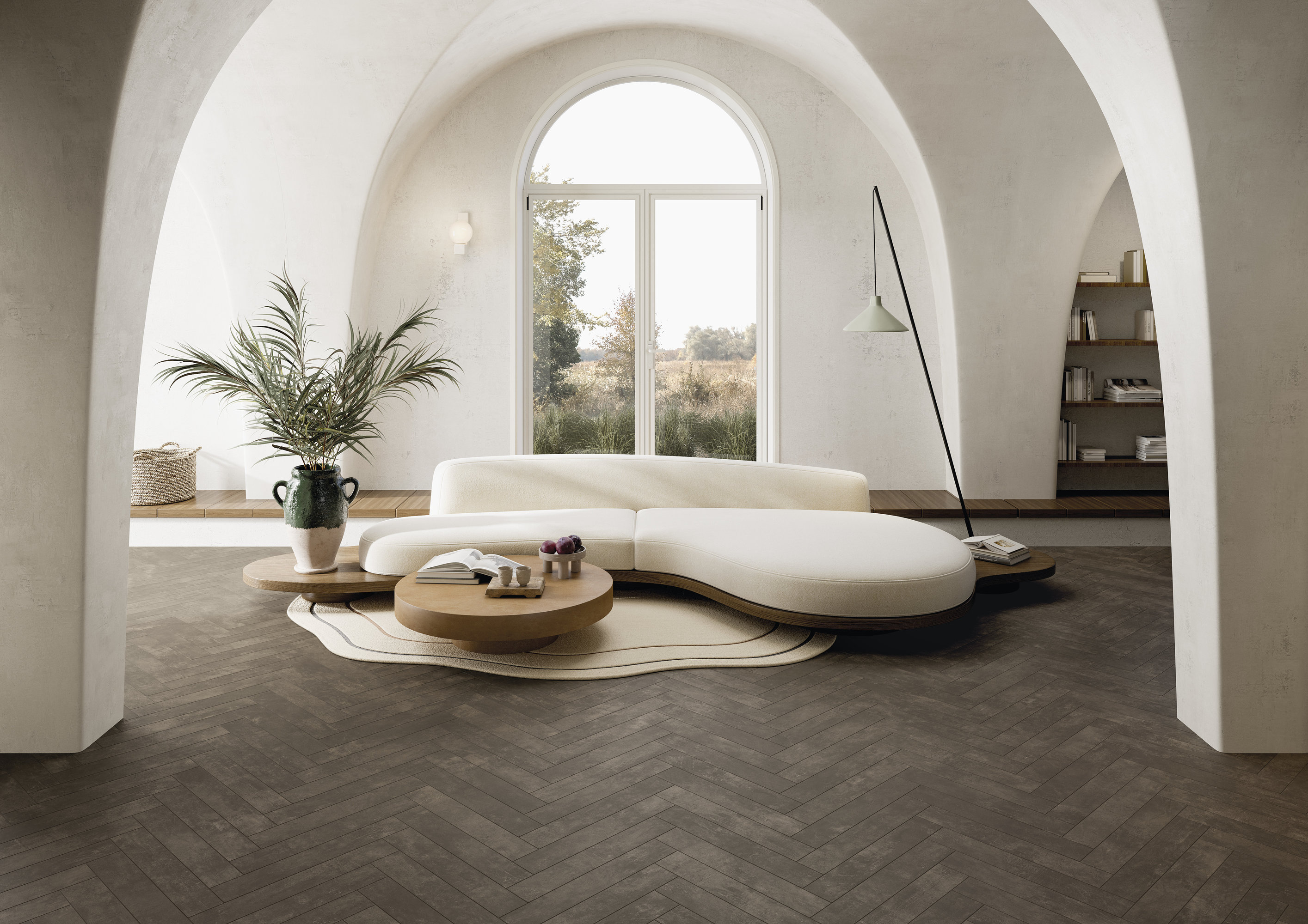 Carrelage foncé à chevrons dans salon lumineux et moderne.