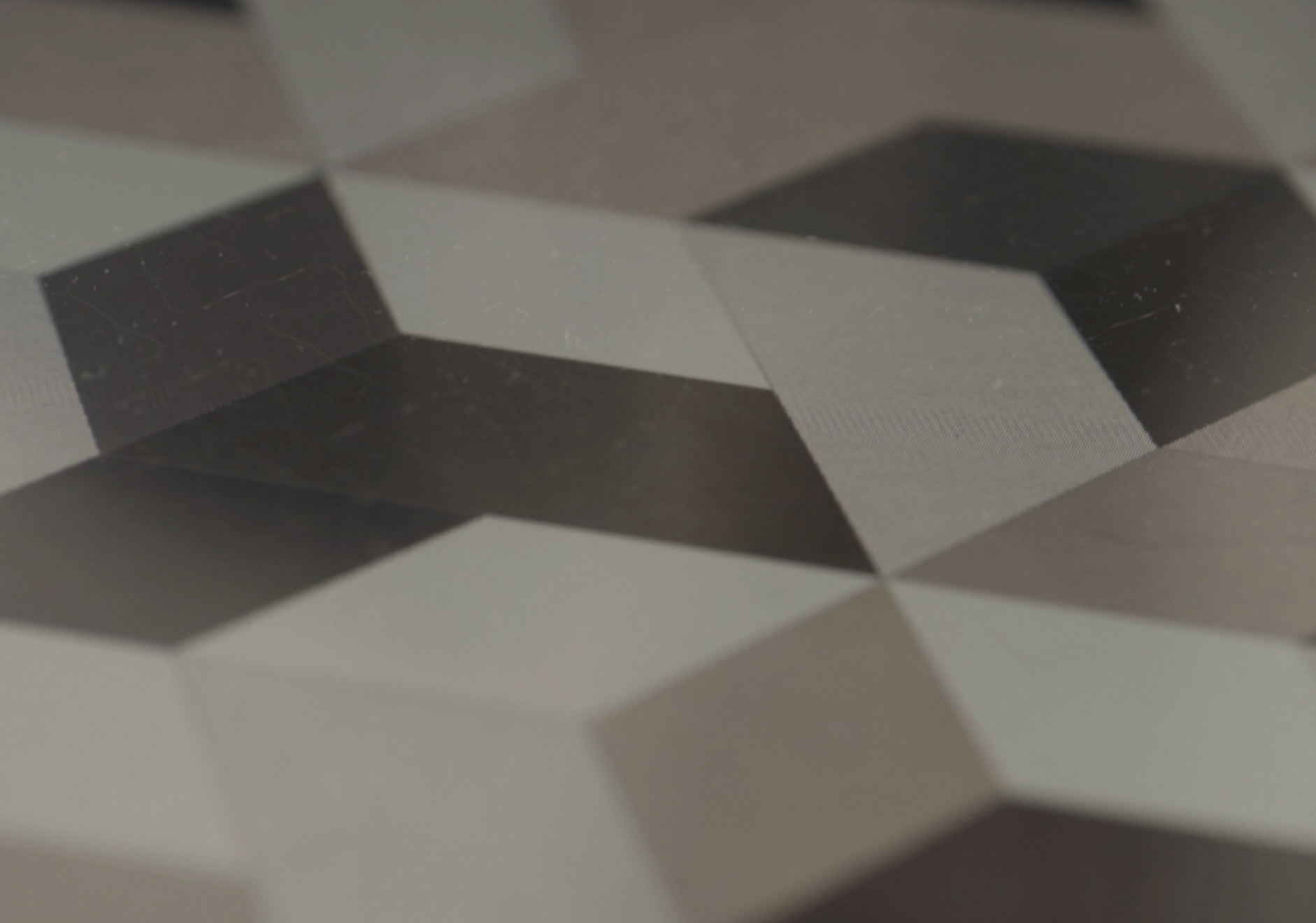 Carreaux gris avec motif géométrique de cubes 3D.