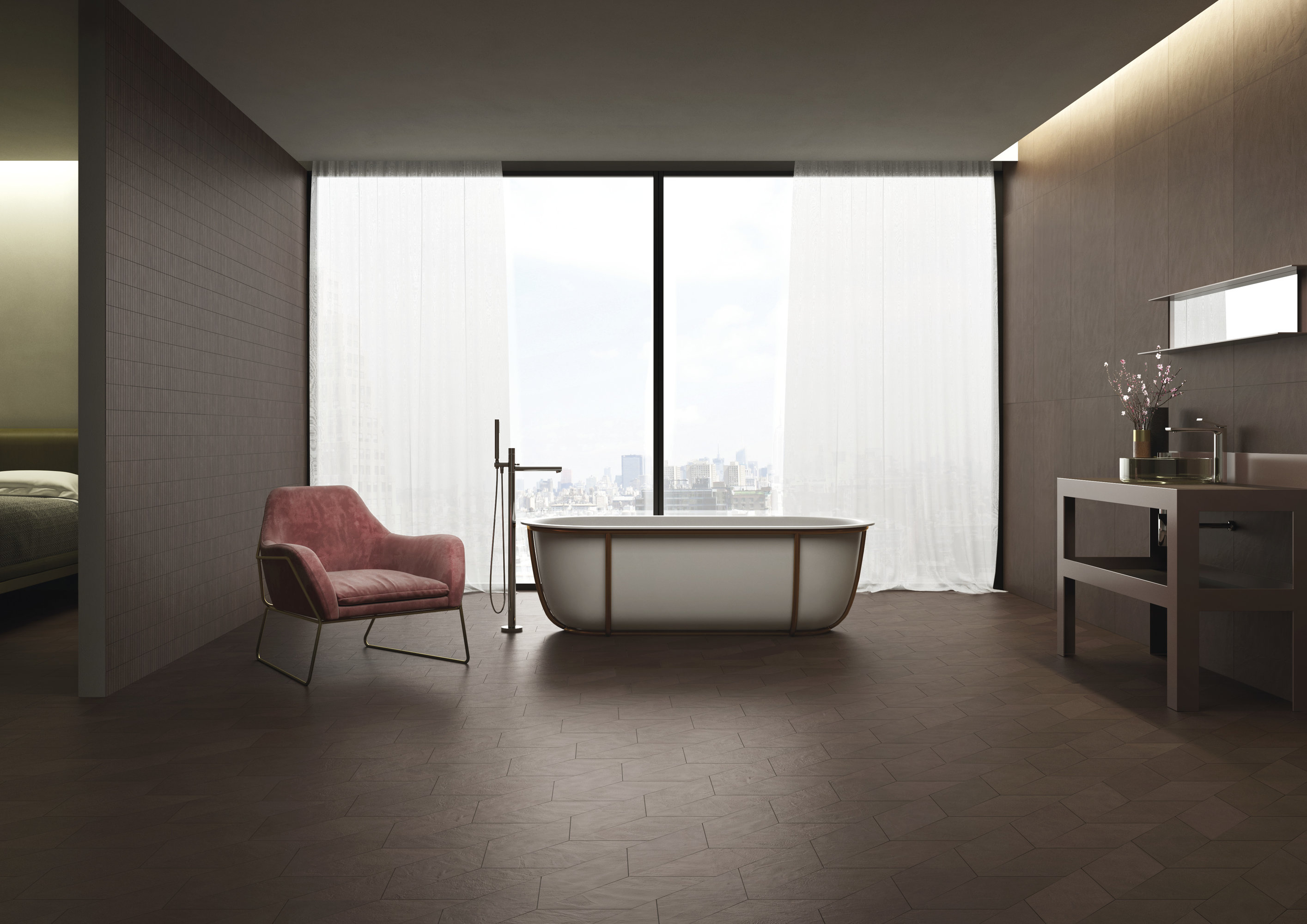 Salle de bain luxueuse avec carrelage de sol foncé Porcelaingres, baignoire îlot et fauteuil.