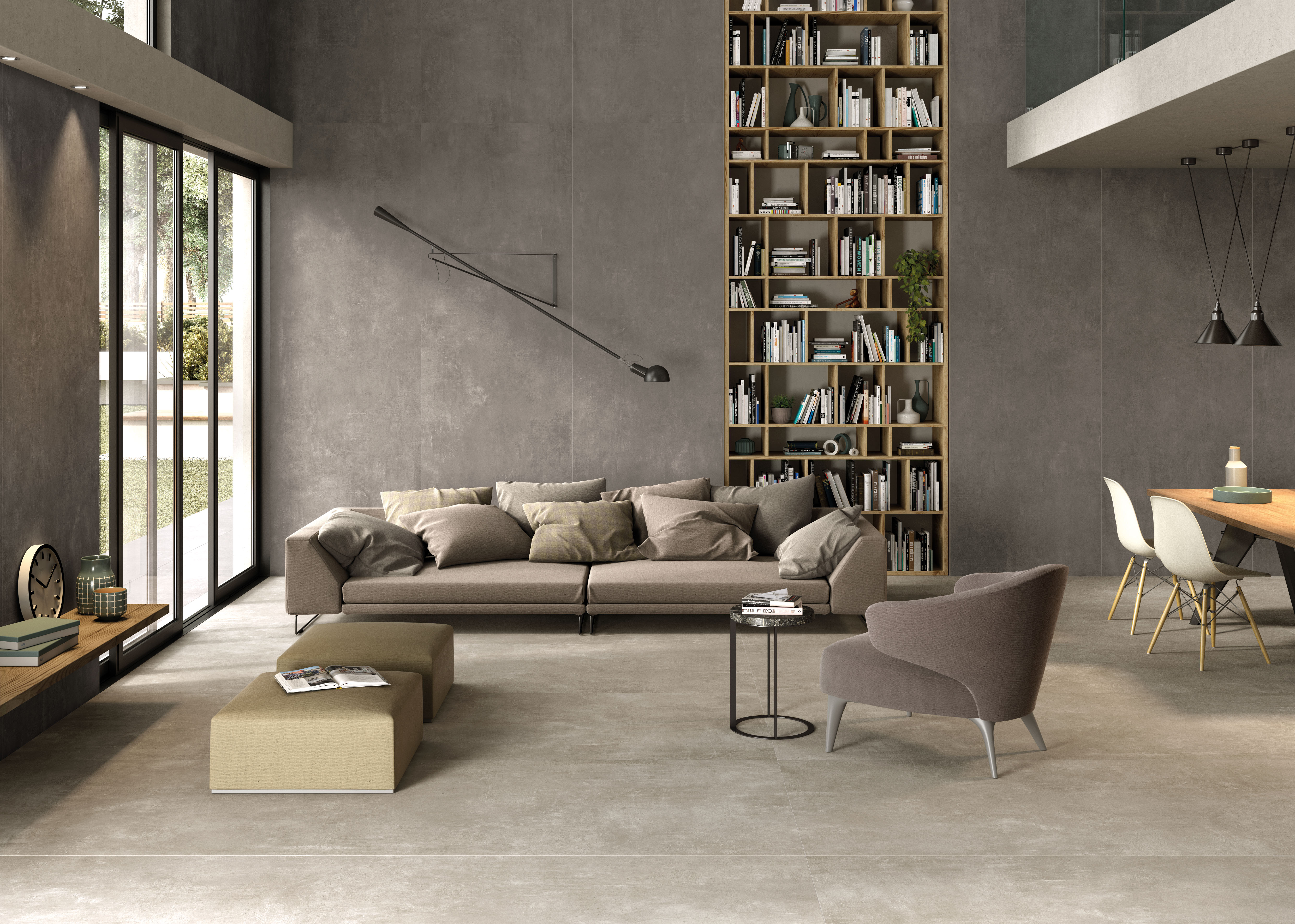 Modernes Wohnzimmer mit großformatigen Fliesen an Boden und Wand in eleganter Betonoptik.