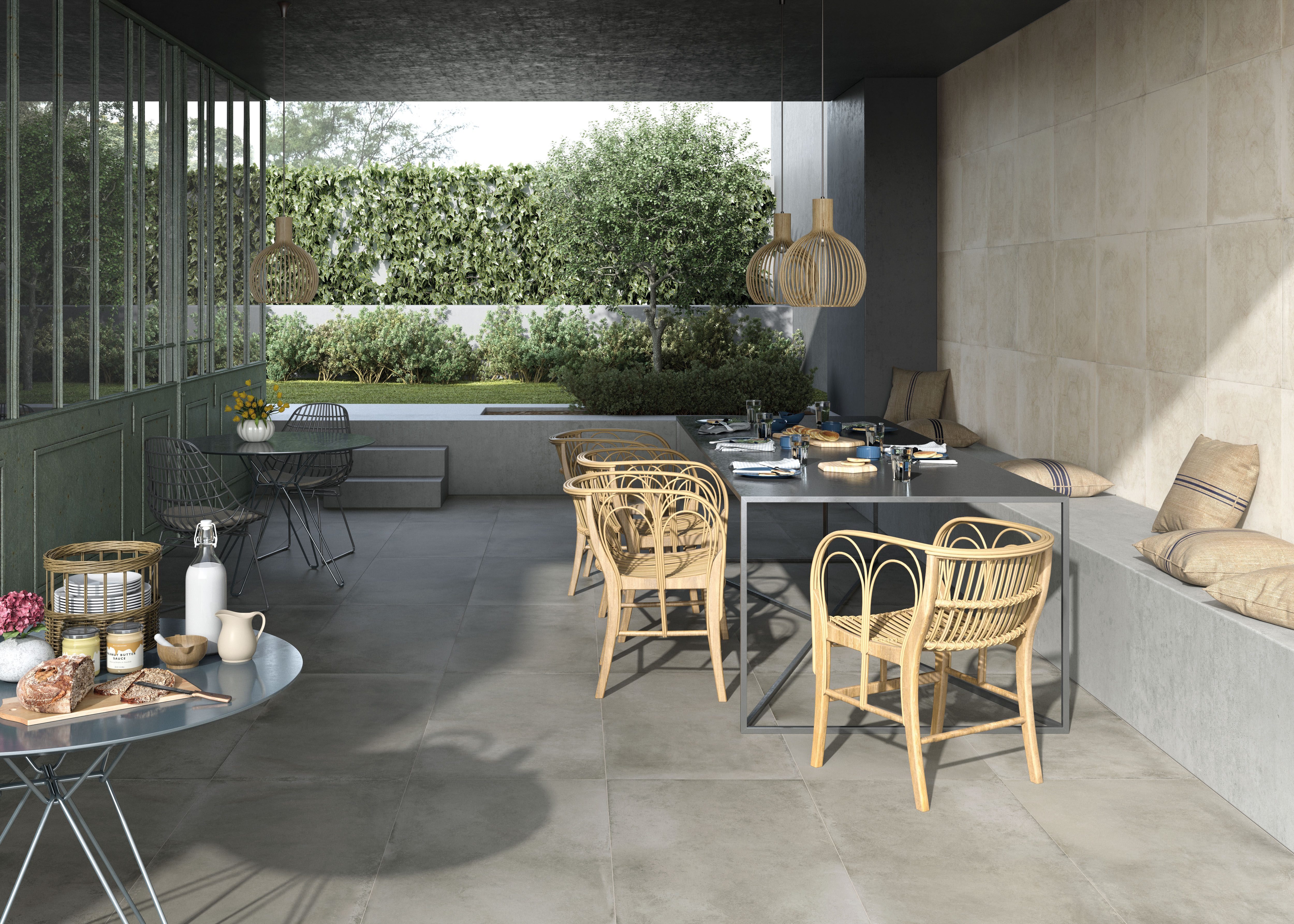 Graue, großformatige Outdoor-Fliesen auf einer modernen Terrasse mit Essbereich.